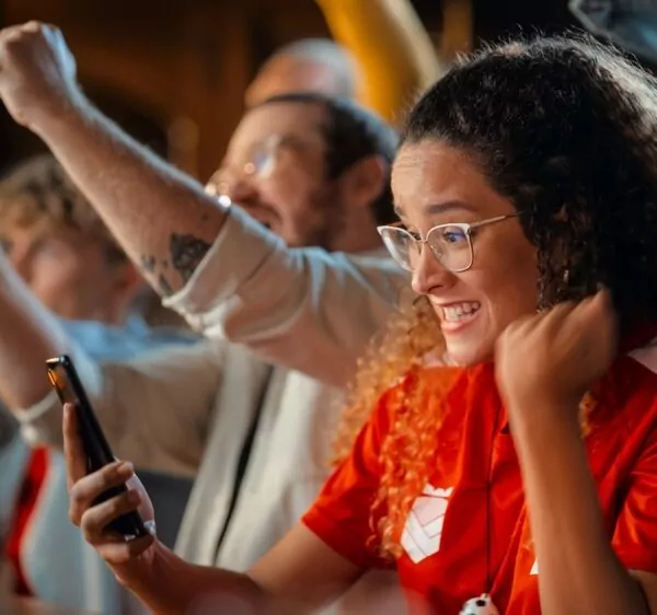 Woman interacting with sports betting, watching game in bar