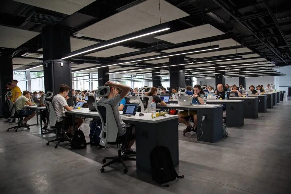 staff augmentation software developers, dozens working in a room with computers.